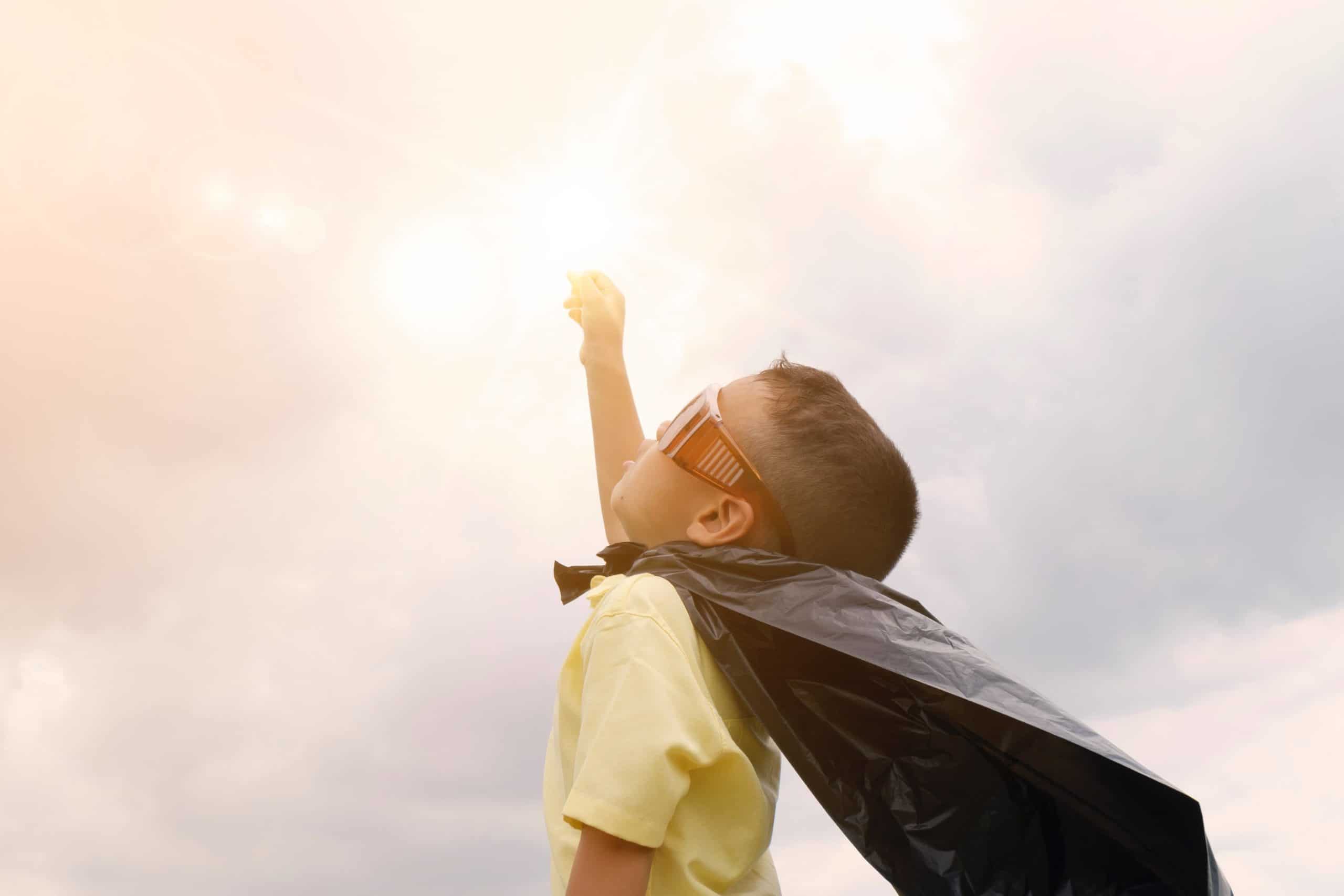 A child engaging in imaginative play as a superhero